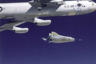 An M2-F3 lifting body is seen being launched from NASA's B-52 mothership at the NASA Flight Research Center (today, Armstrong Flight Research Center) at Edwards Air Force Base in California.