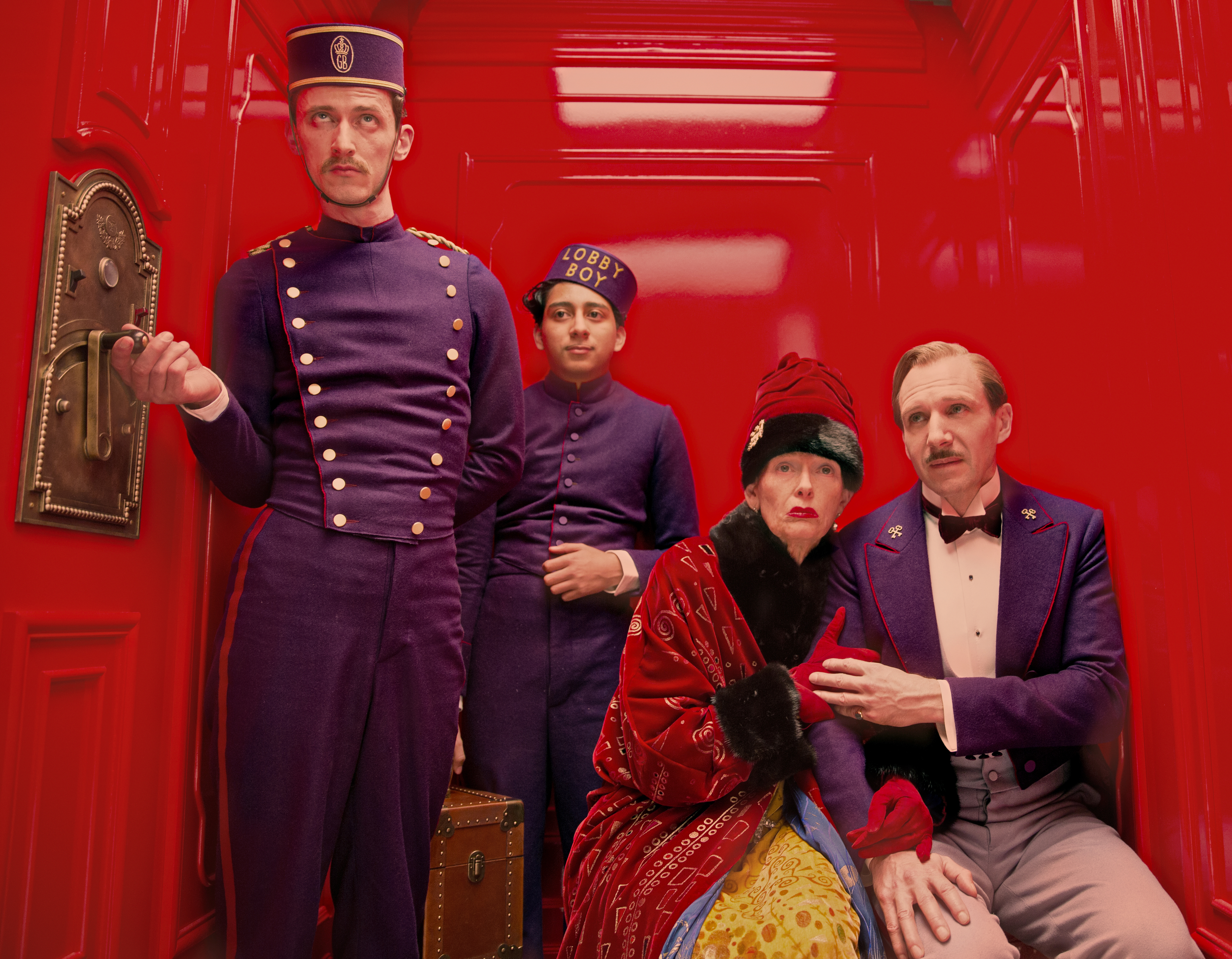 Actors in elevator in scene from Wes Anderson film The Grand Budapest Hotel (2014)