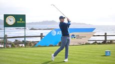 Rory McIlroy holds his finish on an iron shot from the 18th tee during the AT&T Pebble Beach Pro-Am
