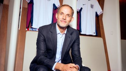 Thomas Tuchel, the new England manager, sits in the dressing room in front of England shirts