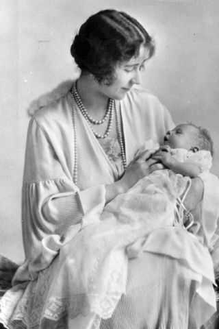 lizabeth, Duchess of York (1900 - 2002) holding her baby, the future Queen Elizabeth II.