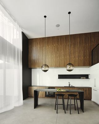 Twin Peaks Residences interior with double height kitchen and bar area