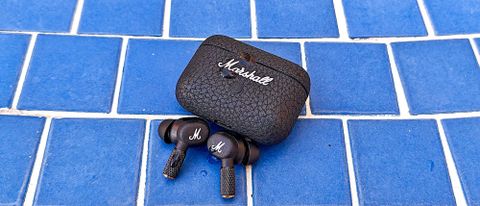 Marshall Motif II with charging case on a blue tiled surface
