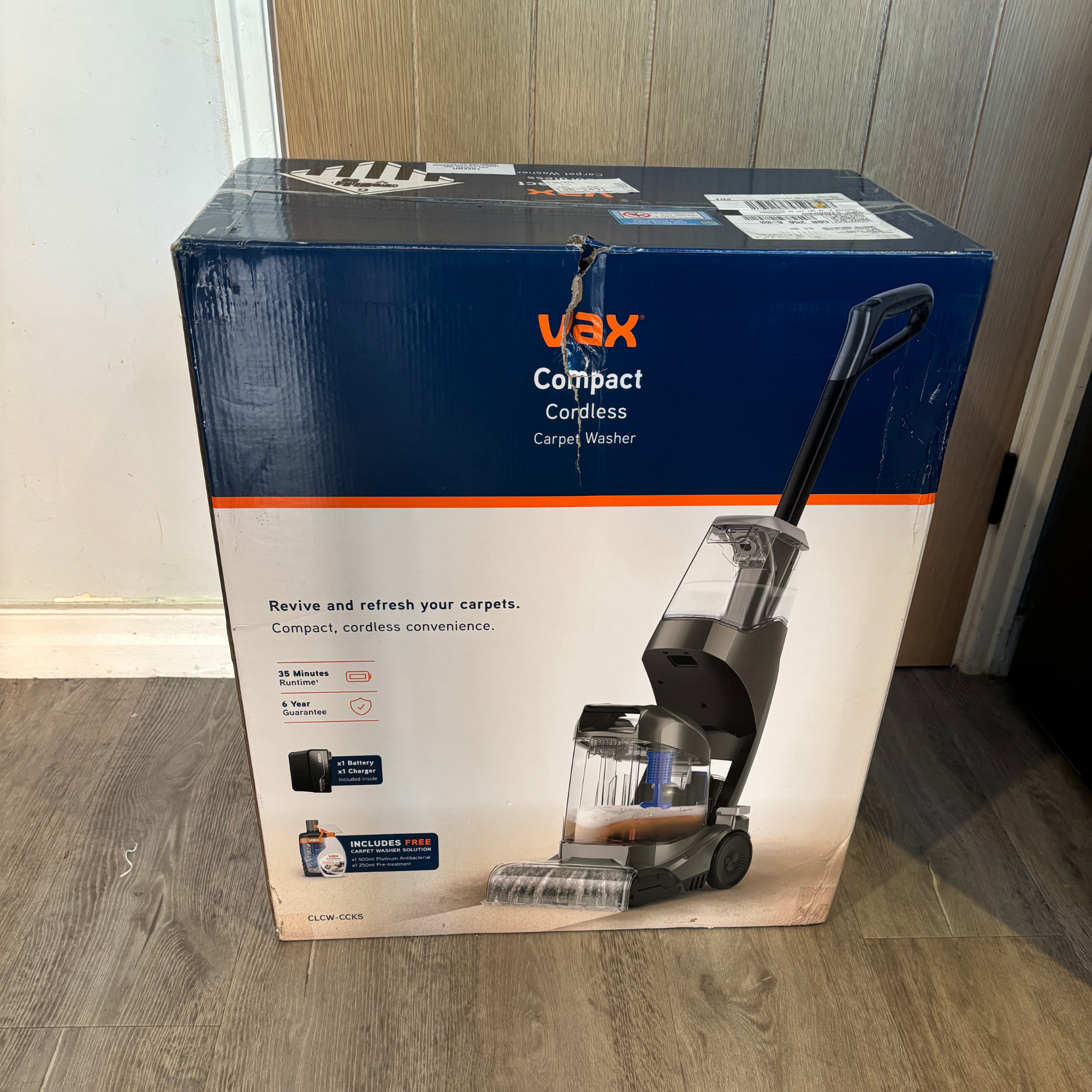 Front view of the VAX Compact Cordless Carpet Washer branded packaging 