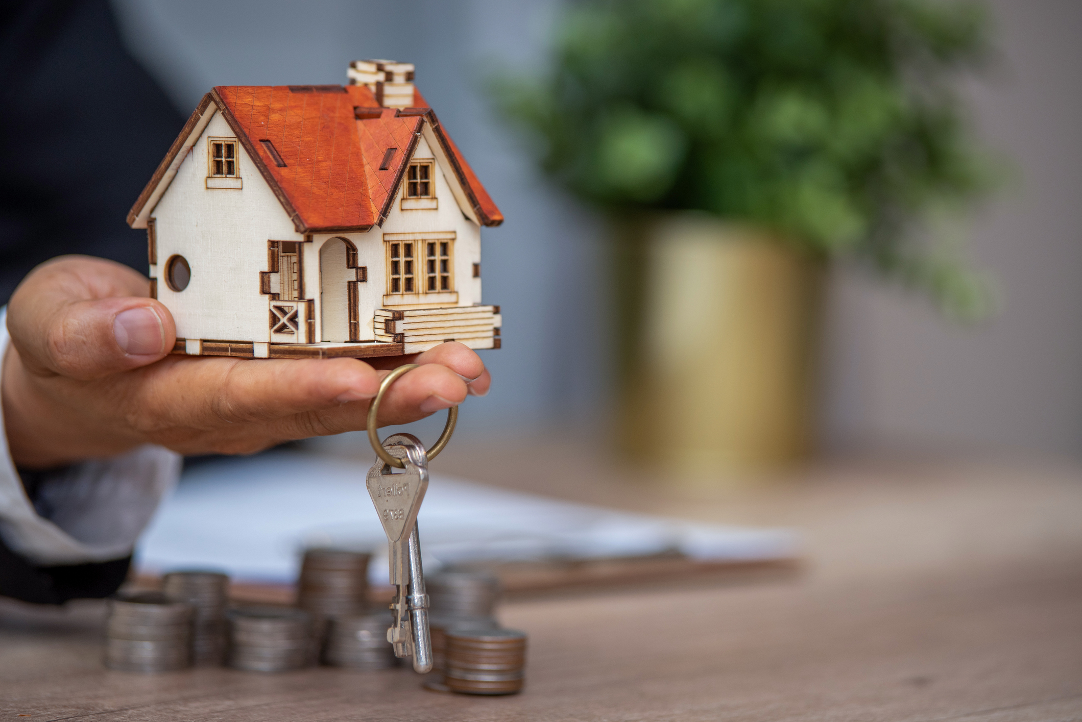 Model home held in palm with keys
