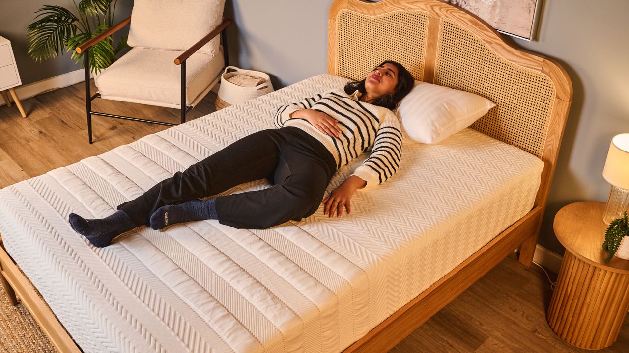 Our tester sleeps on her back while testing the Leesa Legend Hybrid Mattress
