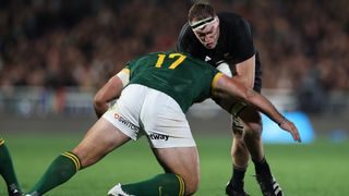 Brodie Retallick (R) takes a hard tackle ahead of the Rugby World Cup live stream 