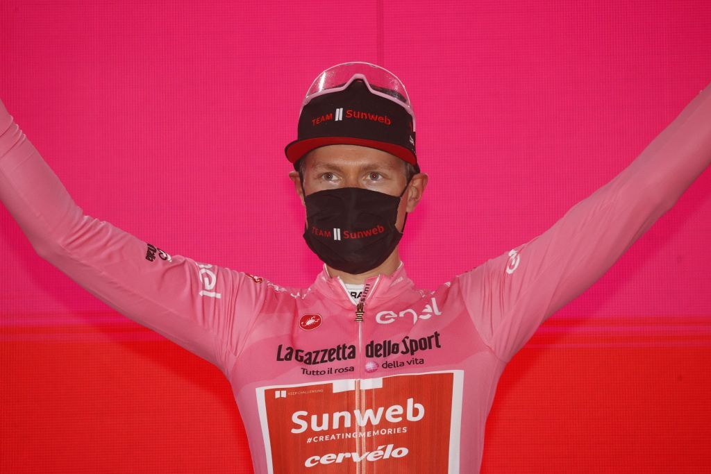 Team Sunweb rider Netherlands Wilco Kelderman wearing the overall leaders pink jersey celebrates on the podium after the 19th stage of the Giro dItalia 2020 cycling race a 258kilometer route between Morbegno and Asti on October 23 2020 Heavy rain has interrupted on October 23 2020 the 19th stage of the Giro dItalia following protests by the riders in the face of difficult weather conditions Todays stage was planned to be a flat 258km ride between Morbegno and Asti but was cut back 100km after riders revolted when faced with pelting rain in the northern region of Lombardy Photo by Luca Bettini AFP Photo by LUCA BETTINIAFP via Getty Images