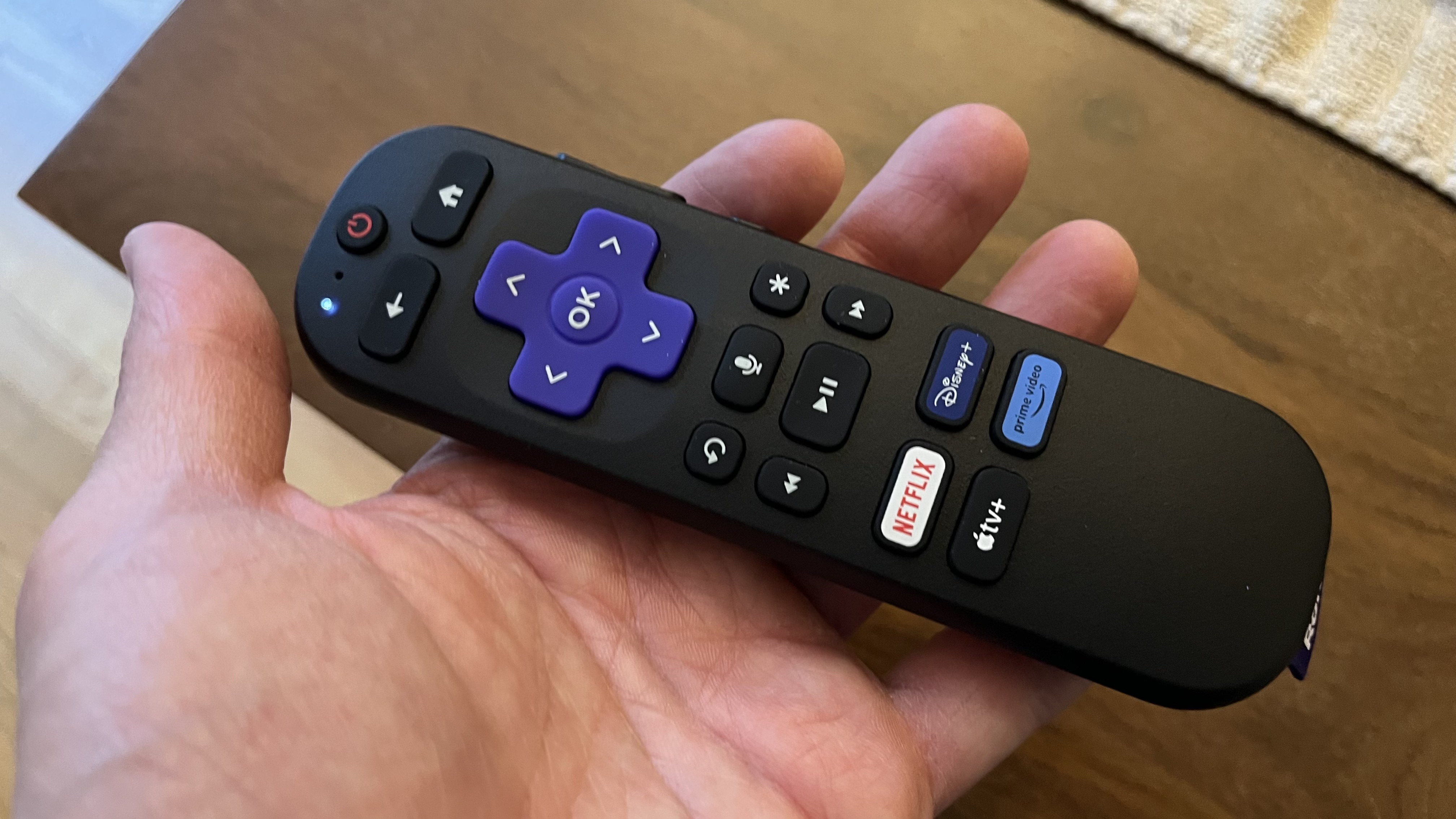 Roku Streaming Stick remote held in hand