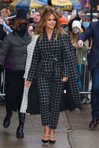 Halle Berry wears a checked jumpsuit as she's seen attending Good Morning America at the ABC Studios in Timesquare Manhattan on November 22, 2021 in New York City.