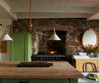 kitchen with brick wall and alcove housing range cooker