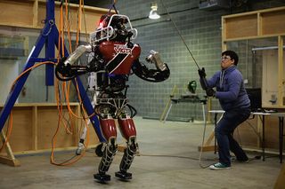 Computer Science in Robotics PhD Alex Stumpf of TU Darmstadt positions the ViGIR (Virginia-Germany Interdisciplinary Robotics) Team robot for testing in preparation for the Defense Advanced Research Projects Agency (DARPA) Robotics Challenge April 10, 2015 in Blacksburg, Virginia.