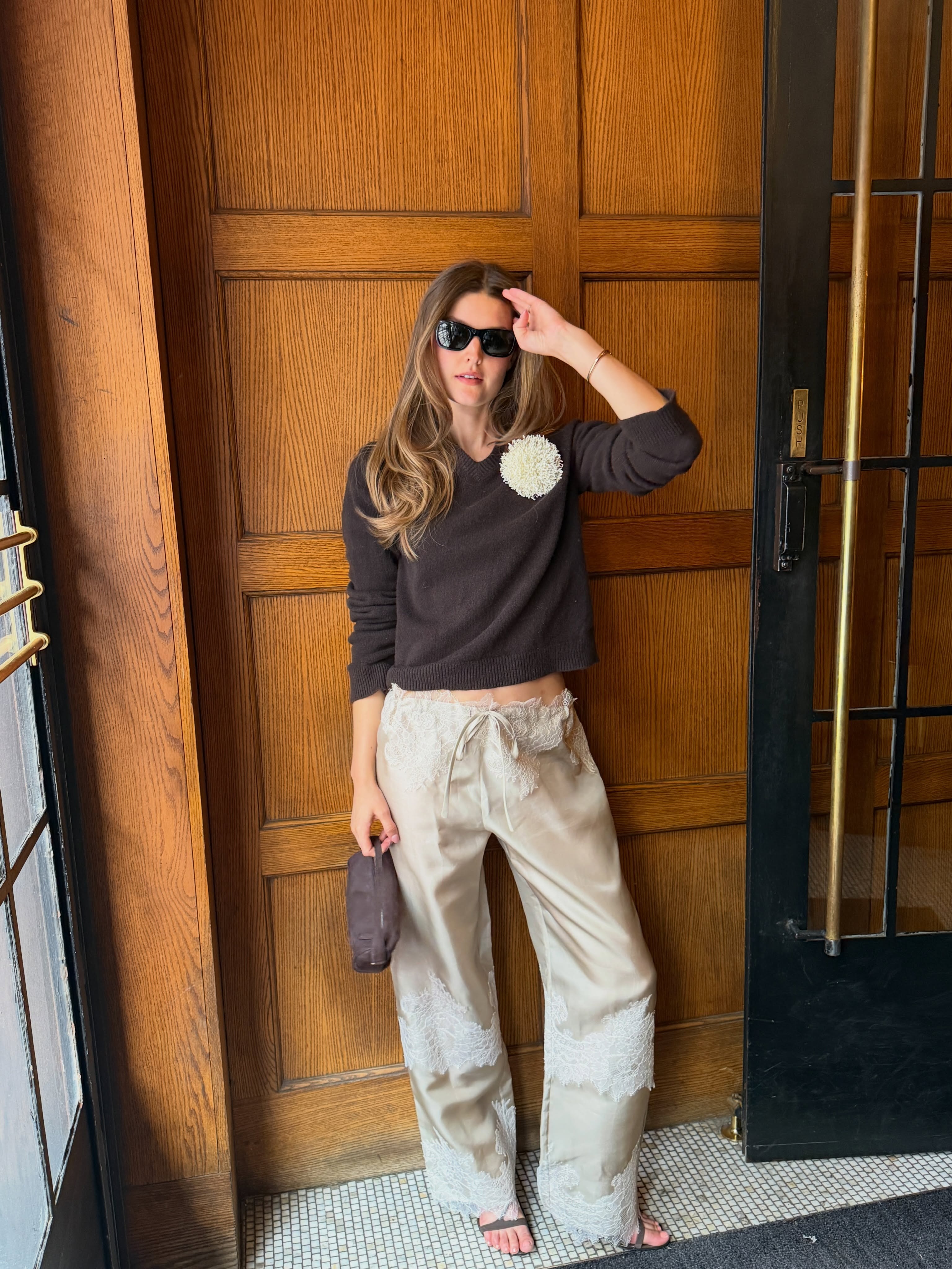 Influencer wearing satin-and-lace pants with sandals