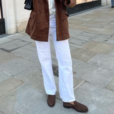 woman in brown suede loafers and jeans