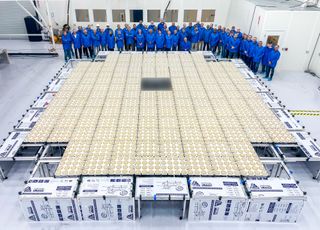 The BlueWalker 3 satellite is seen deployed on Earth with AST SpaceMobile staff around it in a clean room