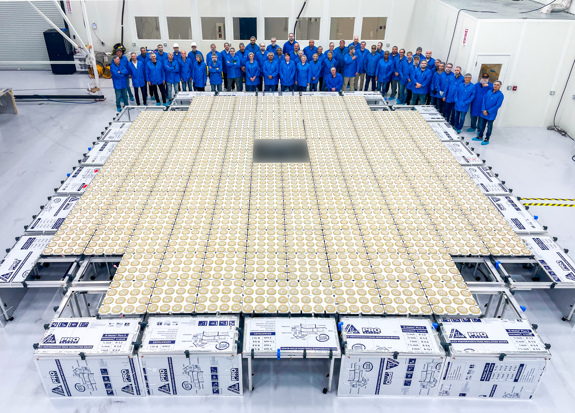The BlueWalker 3 satellite is seen deployed on Earth with AST SpaceMobile staff around it in a clean room