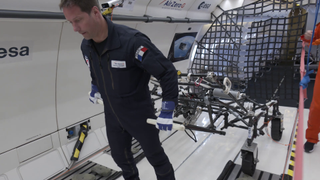 European astronaut Thomas Pesquet testing ESA's lunar wheelbarrow during a parabolic flight simulating lunar gravity in a first-of-a-kind experiment.