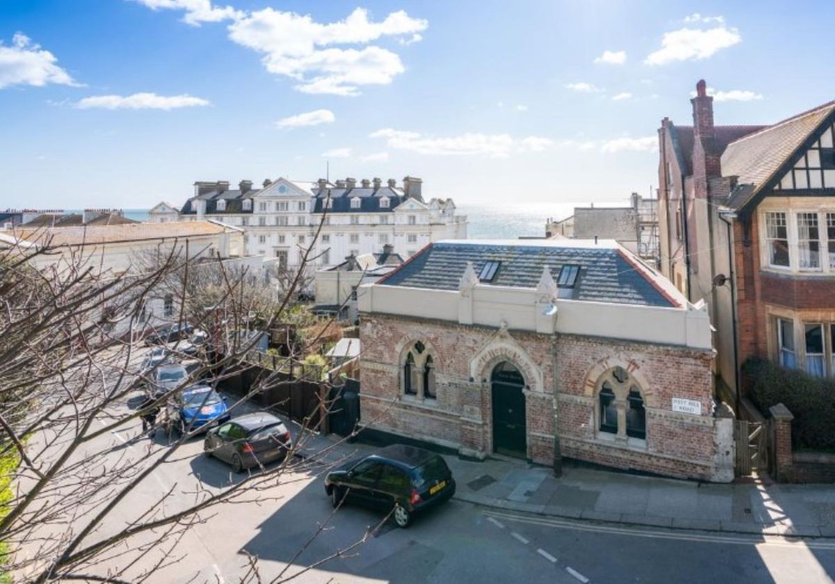 A bath house made with bricks which is detached and has views of the sea