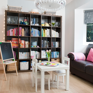 living room with book shelves and blackboard