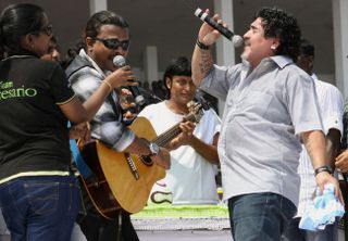 Diego Maradona performs with local musicians in India in October 2012.