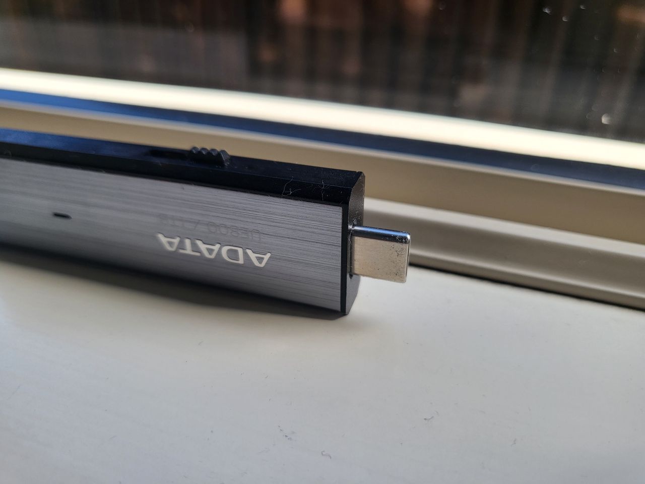 Adata UE800 1TB SSD on a window sill during our test and review process