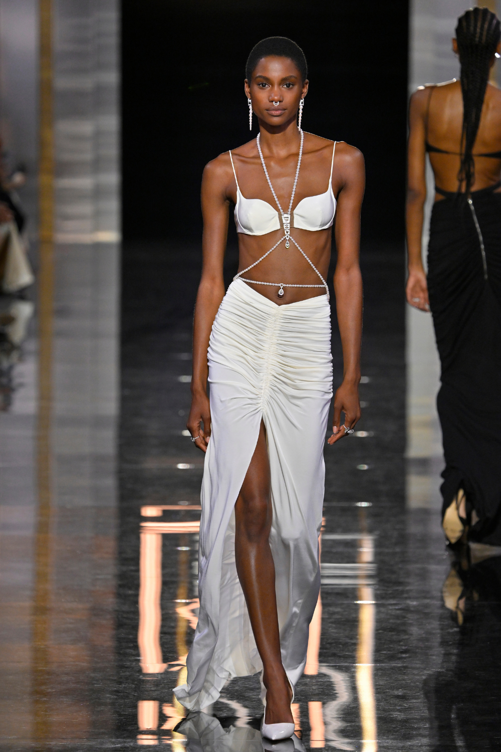 model wearing elaborate diamond necklaces and waist chain