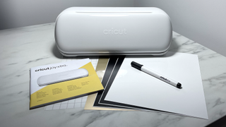 Cricut Joy Xtra review; a small white craft machine and sample materials