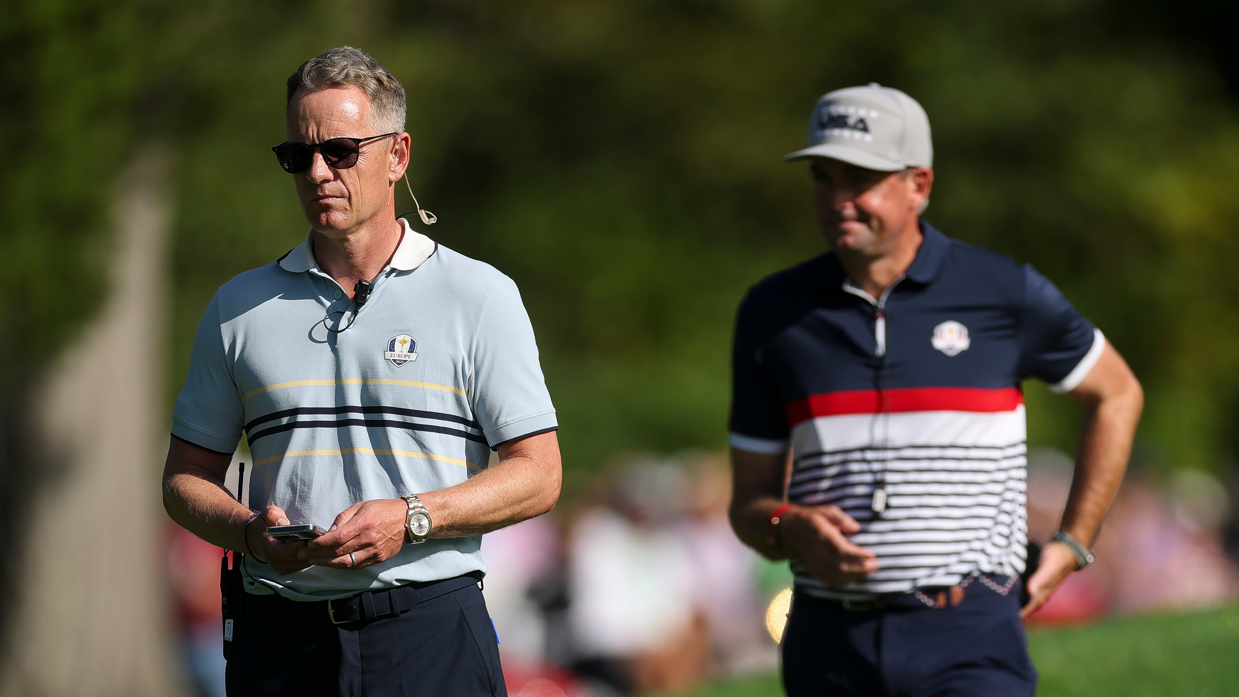 Luke Donald is in focus on the left side of the photo with an out-of-focus Keegan Bradley on the right during the 2025 Ryder Cup at Bethpage Black