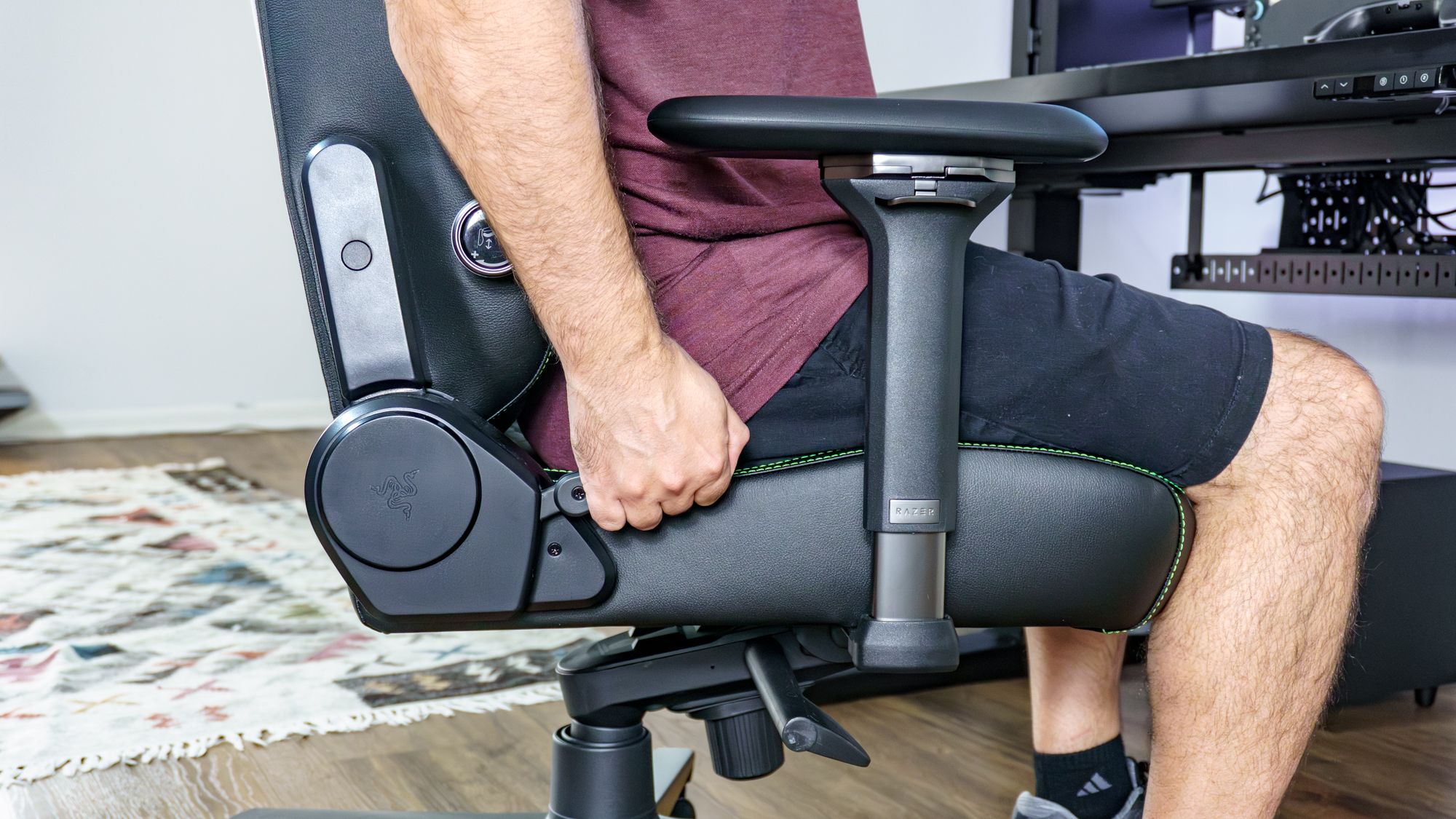 A close-up shot of a person pulling the handbrake-style lever used for reclining in the Razer Iskur V2 NewGen gaming chair