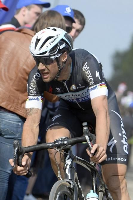 Belgium's Tom Boonen (Omega Pharma-Quick Step) rides through a cobblestoned section