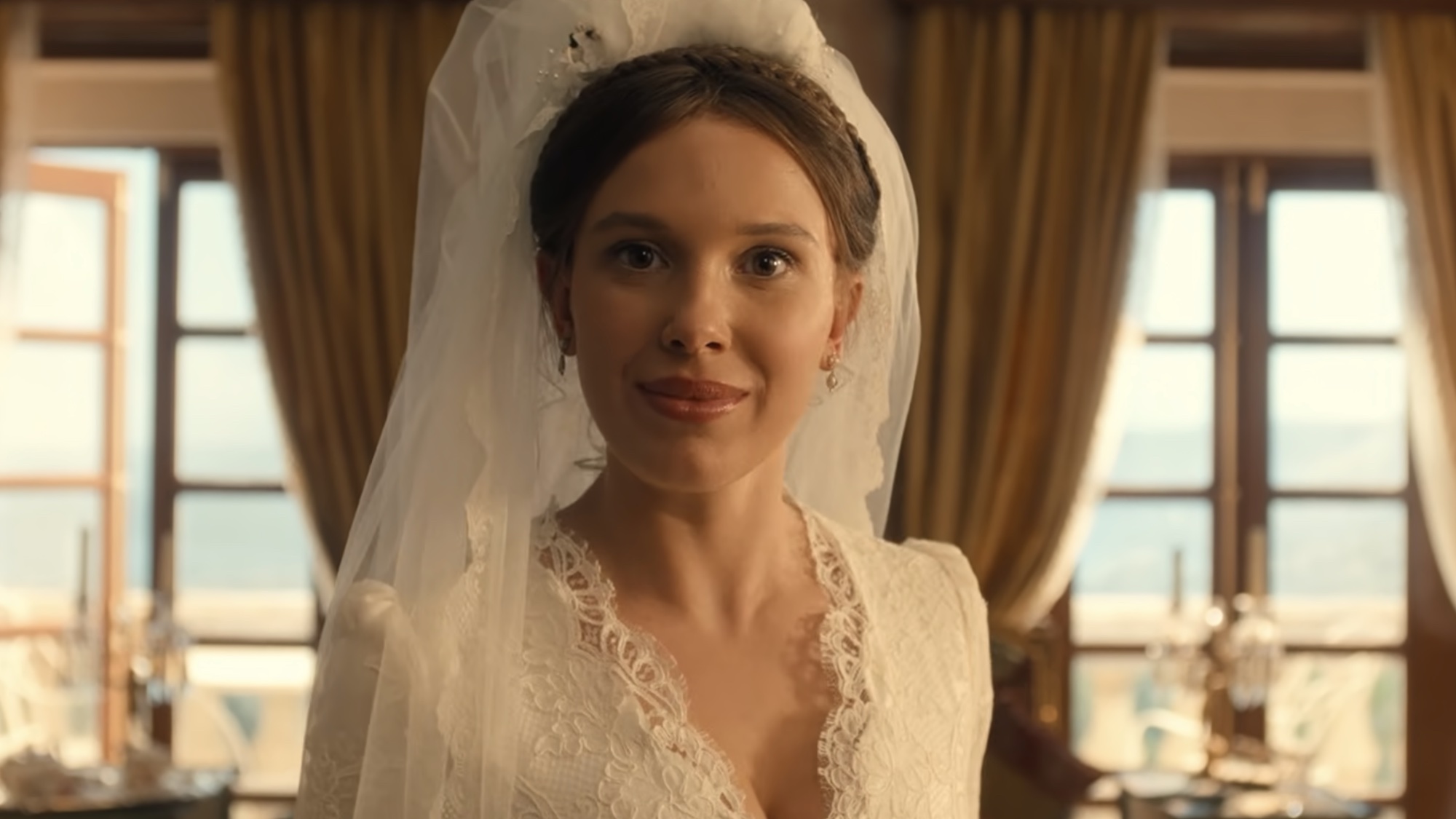 Enola talking to the camera in her wedding dress in Enola Holmes 3.