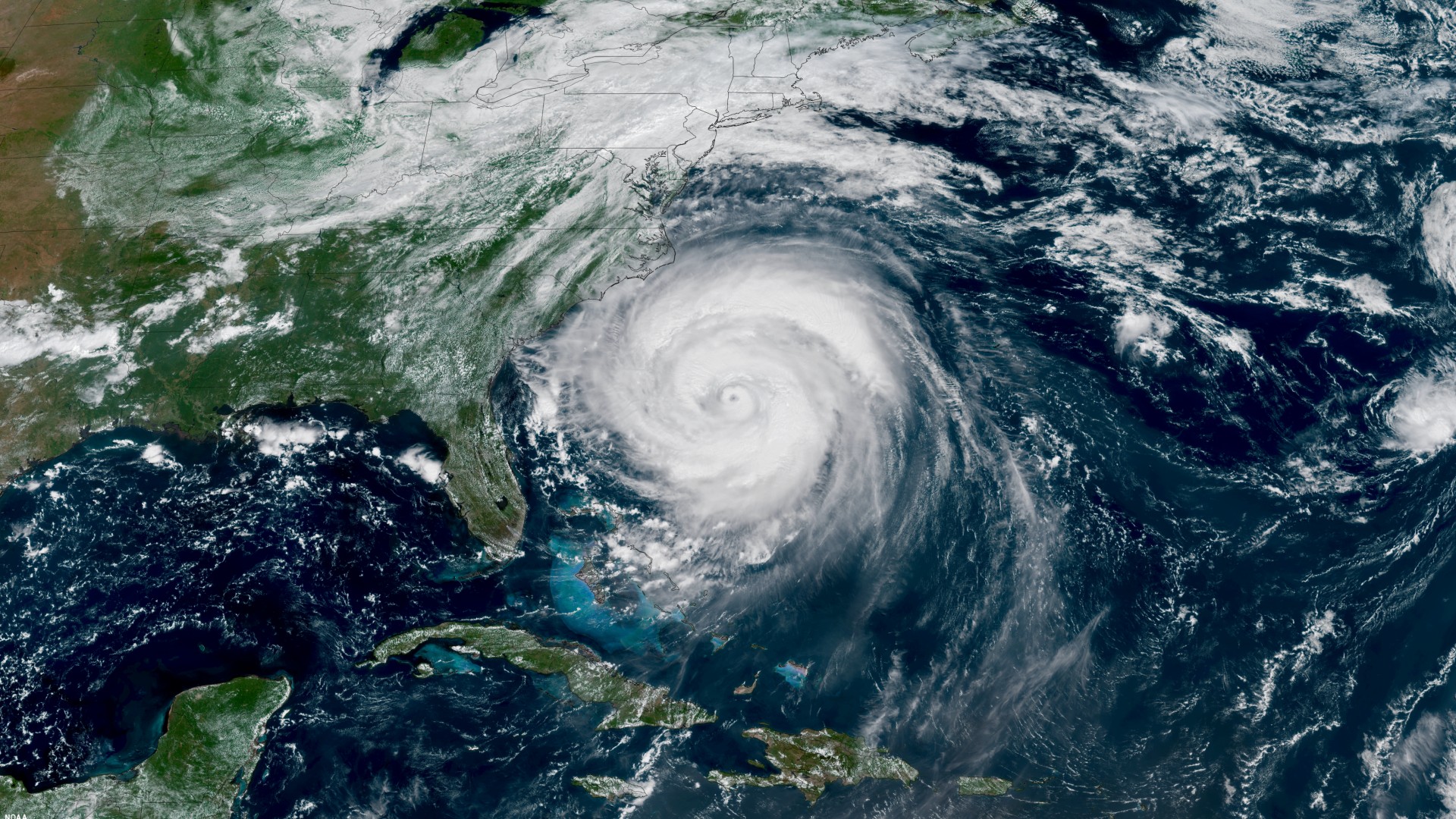 a satellite image of the united states east coast shows a swirling storm just off the coast of florida