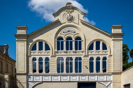The front of Bouvet Ladubay's winery, a cream building with arch-shaped windows, and 'Bouvet Ladubay' written on it.