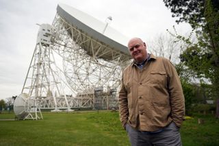Dara is a trained astronomer, here with a large radio telescope.