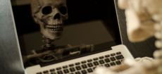 Skeleton worker on a laptop - slow rural broadband speed