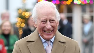 King Charles III smiles as he arrives for the The King's Foundation's annual 'Crafts at Christmas' at Highgrove Gardens on December 13, 2024