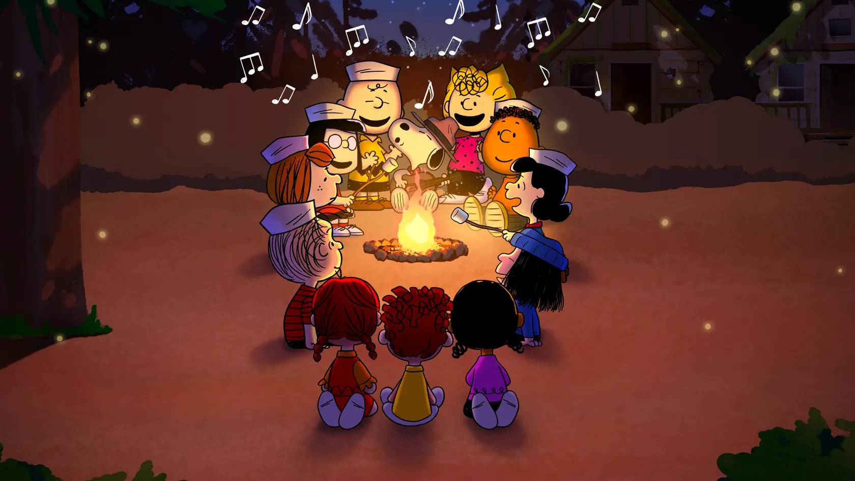 The cast of Snoopy Presents A Summer Musical sat around a camp fire