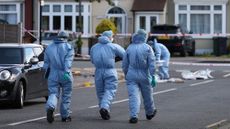 Police forensic officers examining the crime scene in Hainault