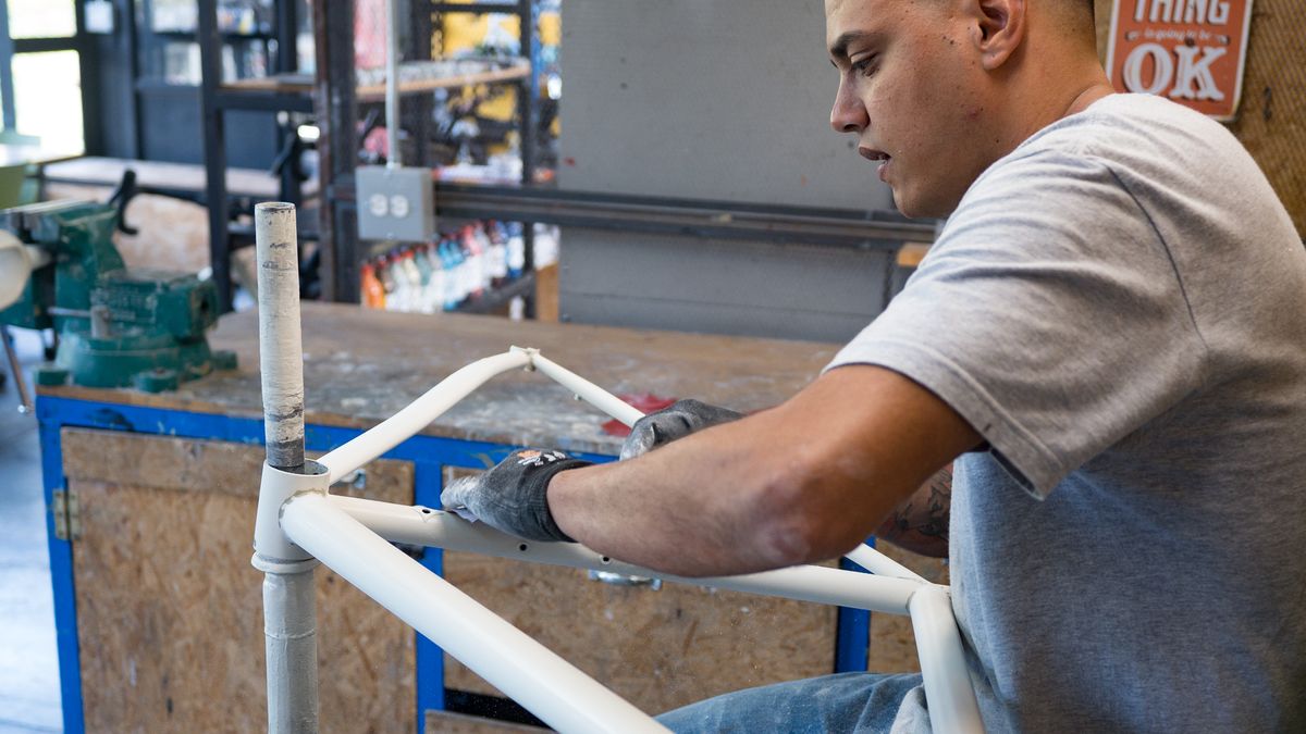 hand sanding a bike frame