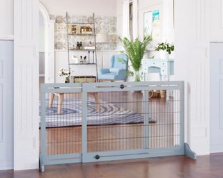A mesh dog gate in a bright living room