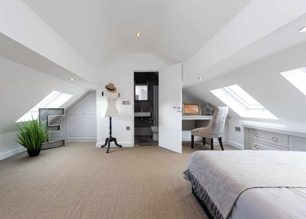 A bedroom loft conversion with velux windows on either side