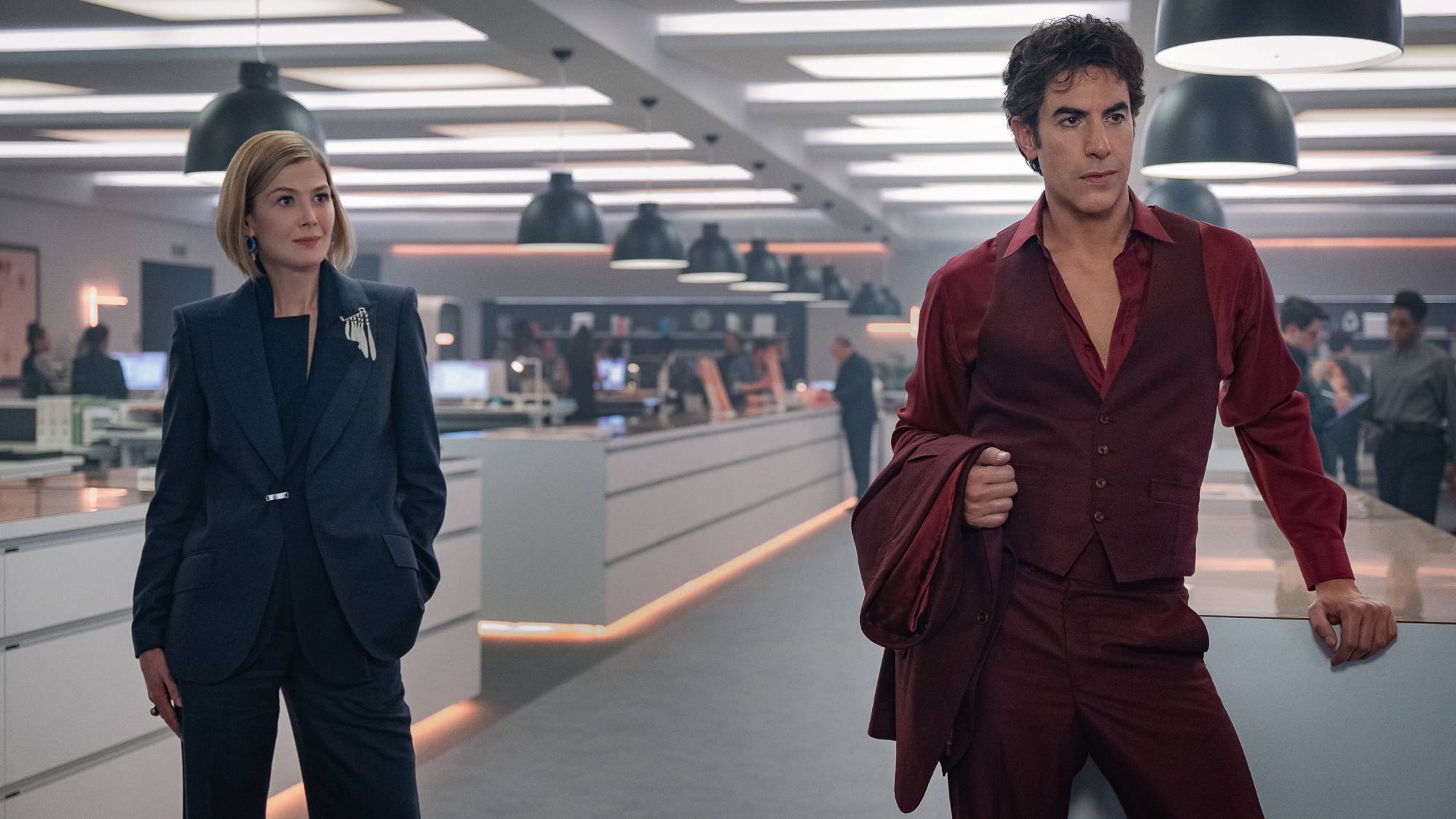 (L-R) Rosamund Pike as Alex Fox and Sacha Baron Cohen as Damien Sachs in "Ladies First"