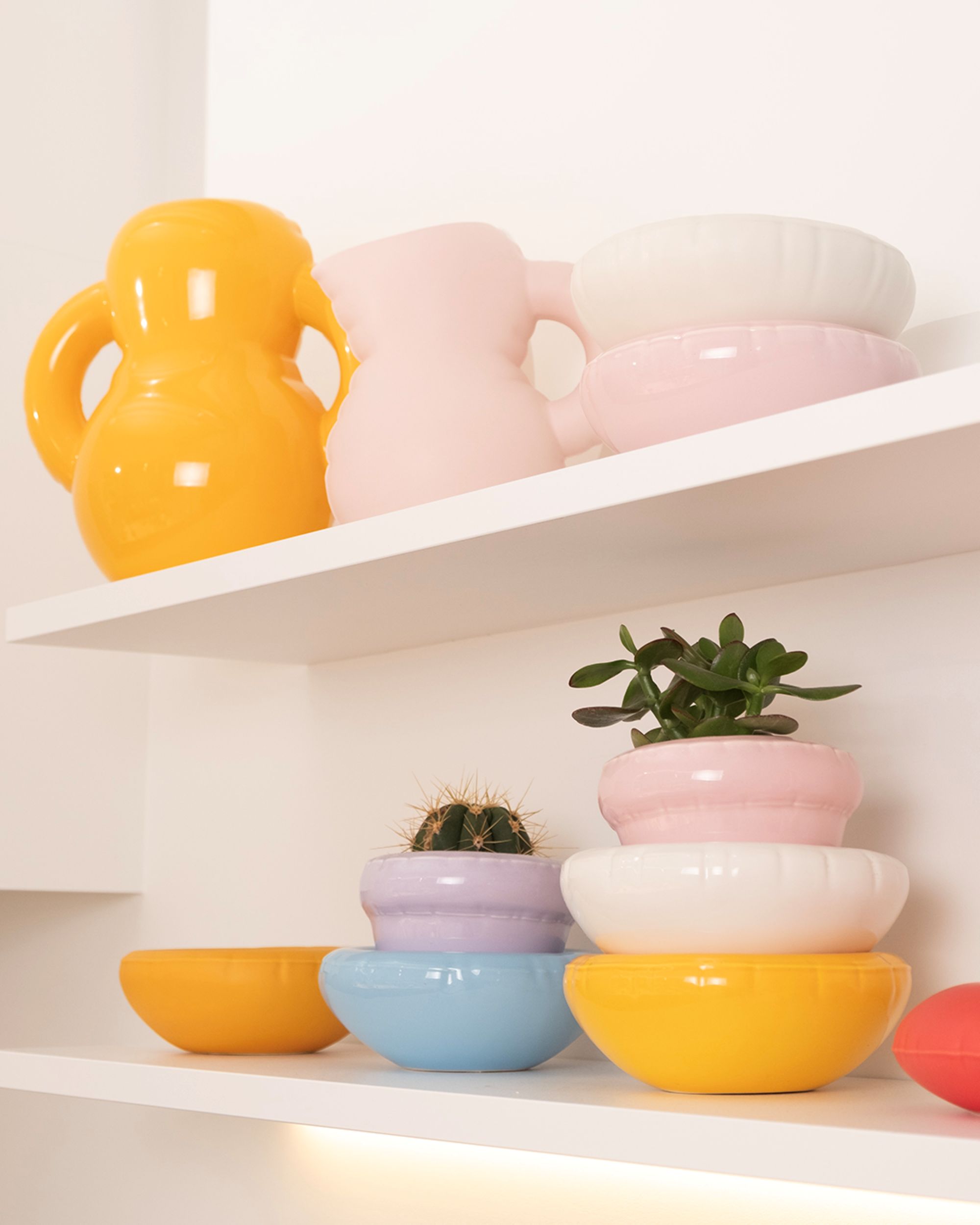 a stack of colorful bowls and vases that look inflated