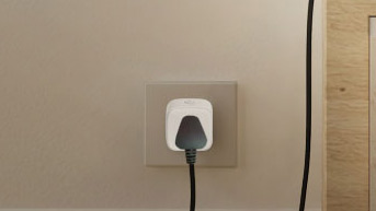 D-Link Mini Wi-Fi Smart Plug DSP-W118 connected to a socket with an appliance plugged in