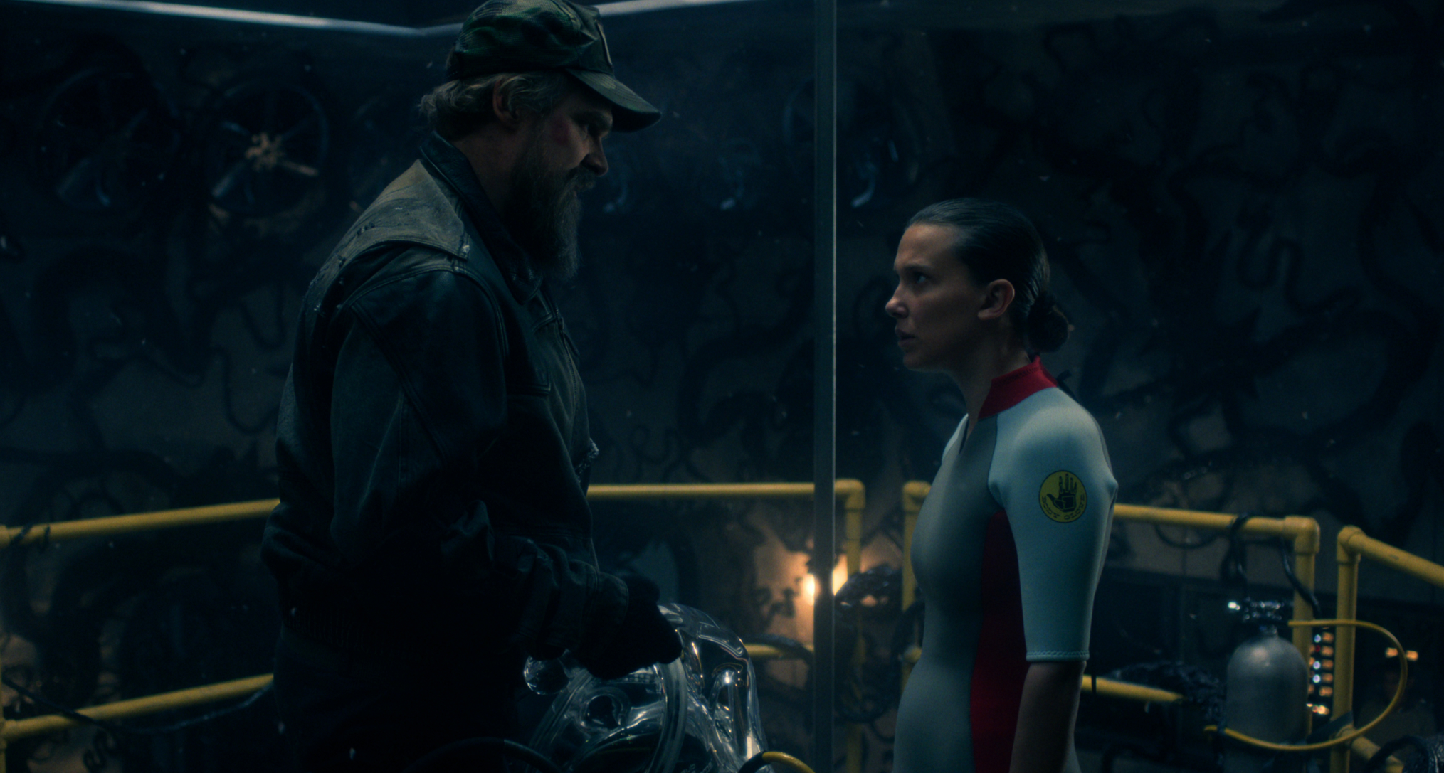 david harbour as hopper and millie bobby brown as eleven talking before she goes in the deprivation tank in the stranger things season 5 finale