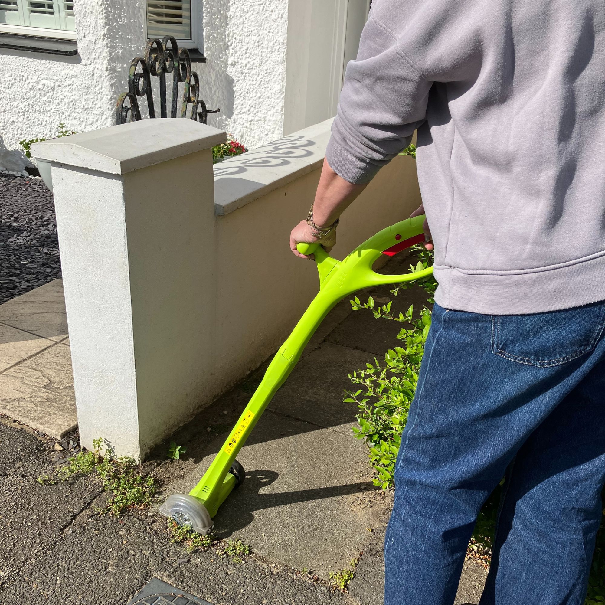 Weed Sweeper tool on pavement