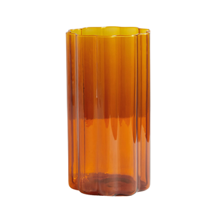 A wavy orange glass vase