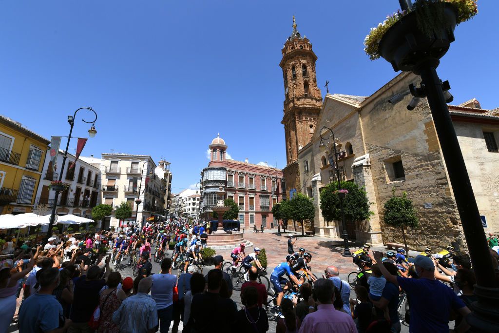 VALDEPEAS DE JAN SPAIN AUGUST 25 A general view of the peloton passing through Antequera City while fans cheer prior to the 76th Tour of Spain 2021 Stage 11 a 1336km stage from Antequera to Valdepeas de Jan 1009m lavuelta LaVuelta21 on August 25 2021 in Valdepeas de Jan Spain Photo by Tim de WaeleGetty Images