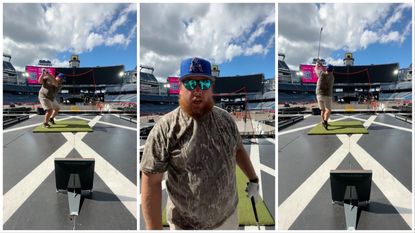 Luke Combs practices his swing at the empty Gillette Stadaium