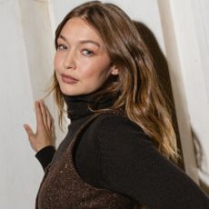 Gigi Hadid wore jeans, cowboy boots, a tank top, and Western hat inspired by her sister, Bella Hadid.